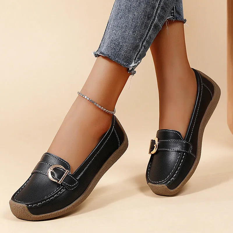 Women's beige casual loafers with round toe and flat heel on a light background.