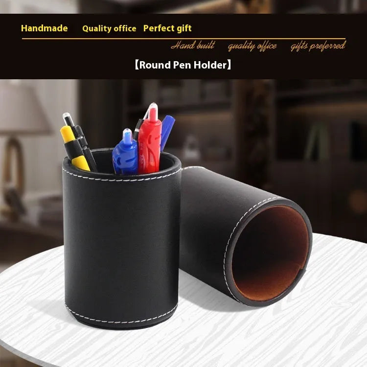 Small round black leather pen container on a desk