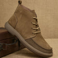 British style grey leather Martin boots with lace-up front and wedge heel on a rubber sole.