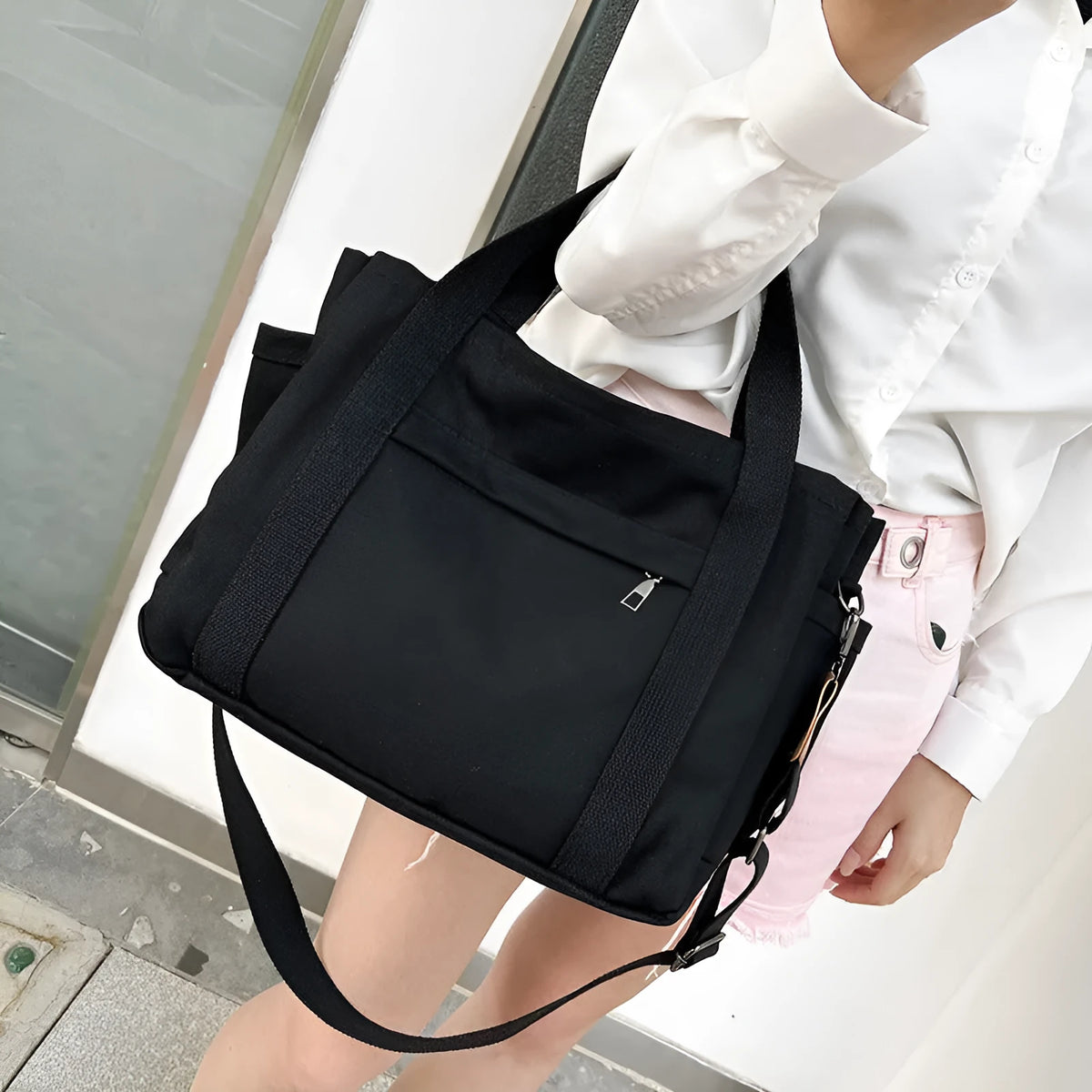 Canvas crossbody tote bag in khaki with open zipper showing internal organiser pockets.