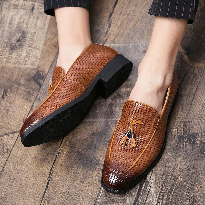 Men's black pointed toe slip-on shoes with a tassel detail on the low-top PU leather upper.