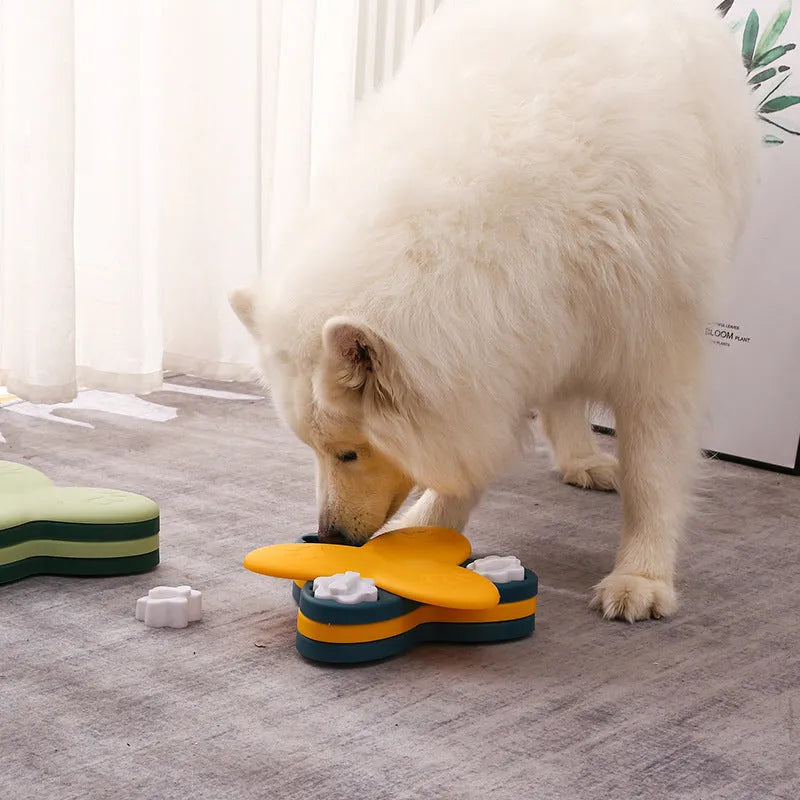 Green and yellow dog puzzle toy with bone covers and rotatable treat dispenser on non-slip base