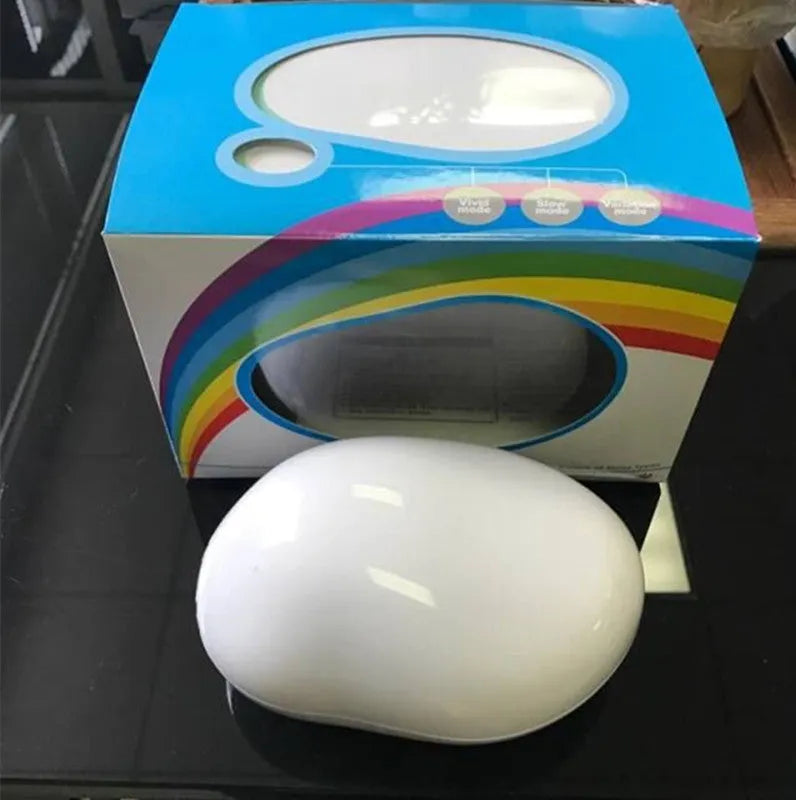 White egg-shaped LED table lamp, 14 x 10 x 6cm, projecting a rainbow onto a wall, USB rechargeable night light