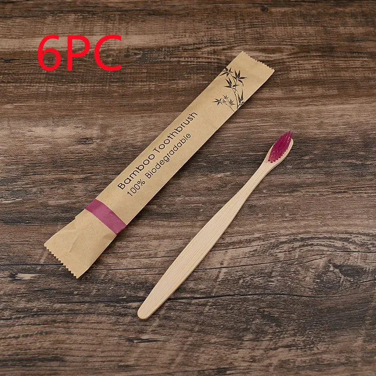 10 bamboo toothbrushes with coloured handles and charcoal bristles displayed together