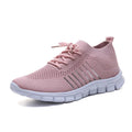 Women's casual flat shoes in beige with mesh upper and front-tie laces on a low EVA sole.