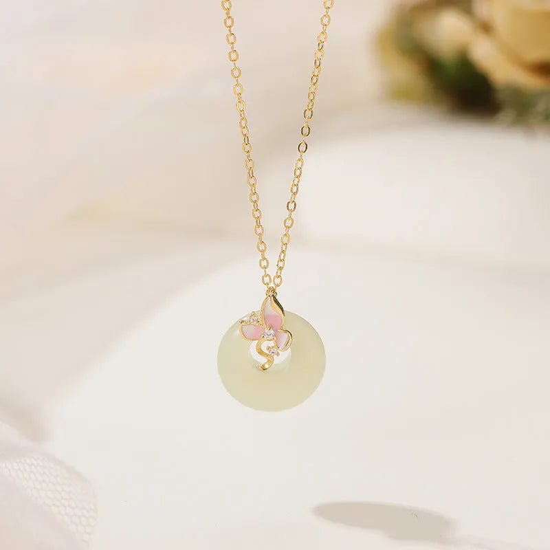 Silver necklace with orchid flower and peace buckle pendant on an O-ring chain, featuring a safety clasp.