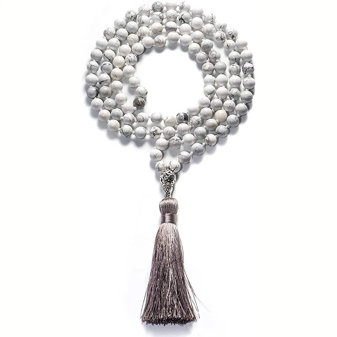 Long agate tassel necklace with geometric beads in multiple natural stone colours on a white background.