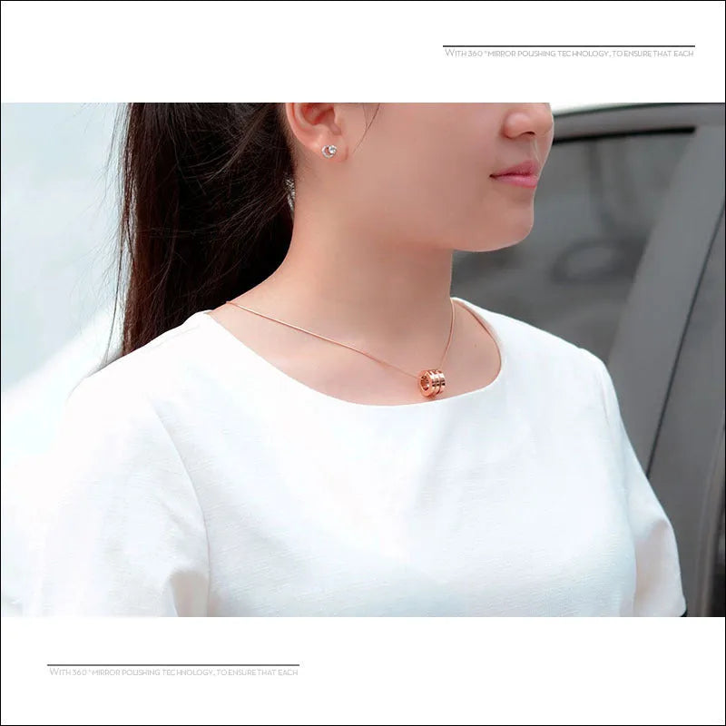Screwdriver pendant necklace in titanium steel with 18K gold plating, shown in gold, rose gold, and steel colour at 45cm or 50cm.