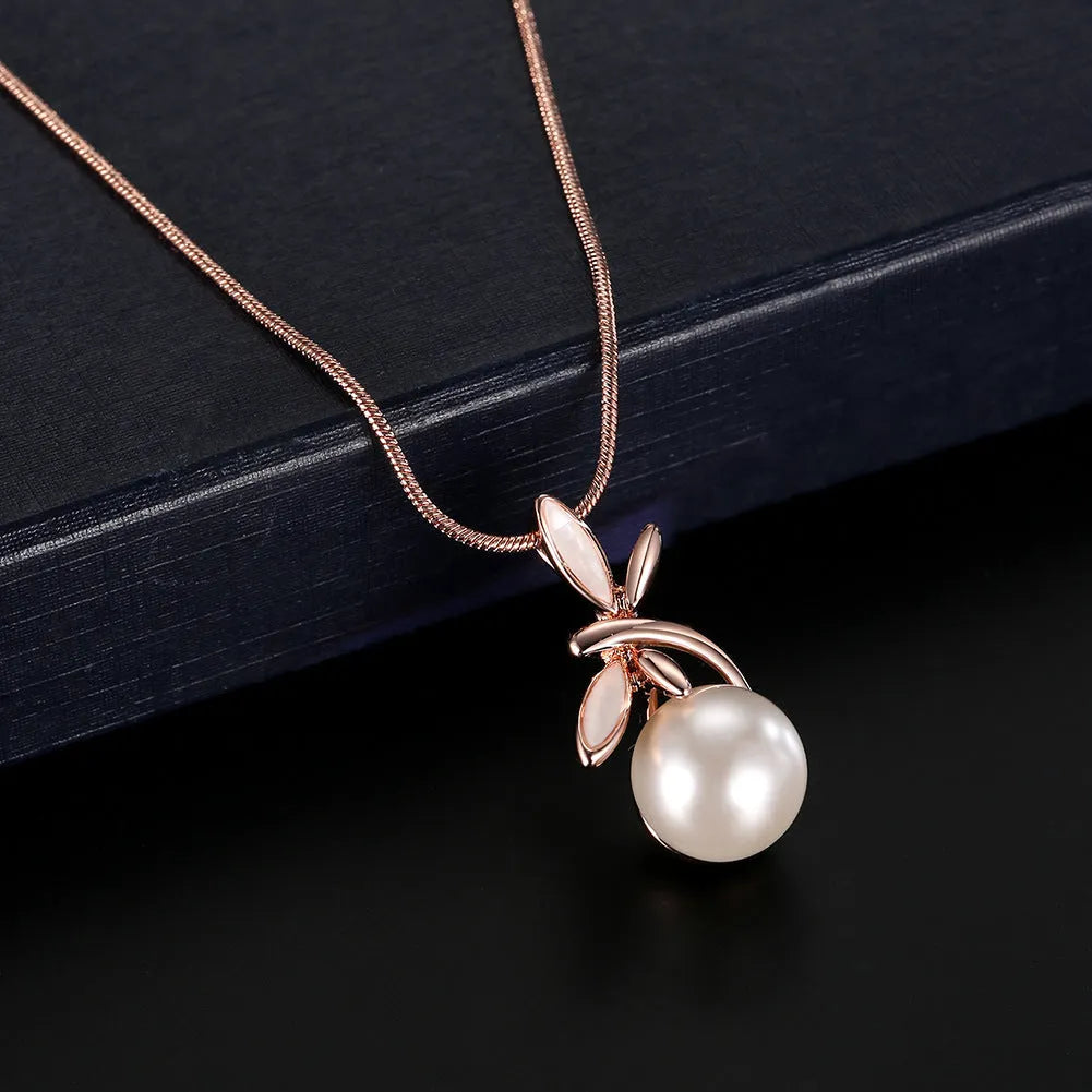 Rose gold bridal jewellery set with pearl necklace and earrings featuring alloy and artificial gems