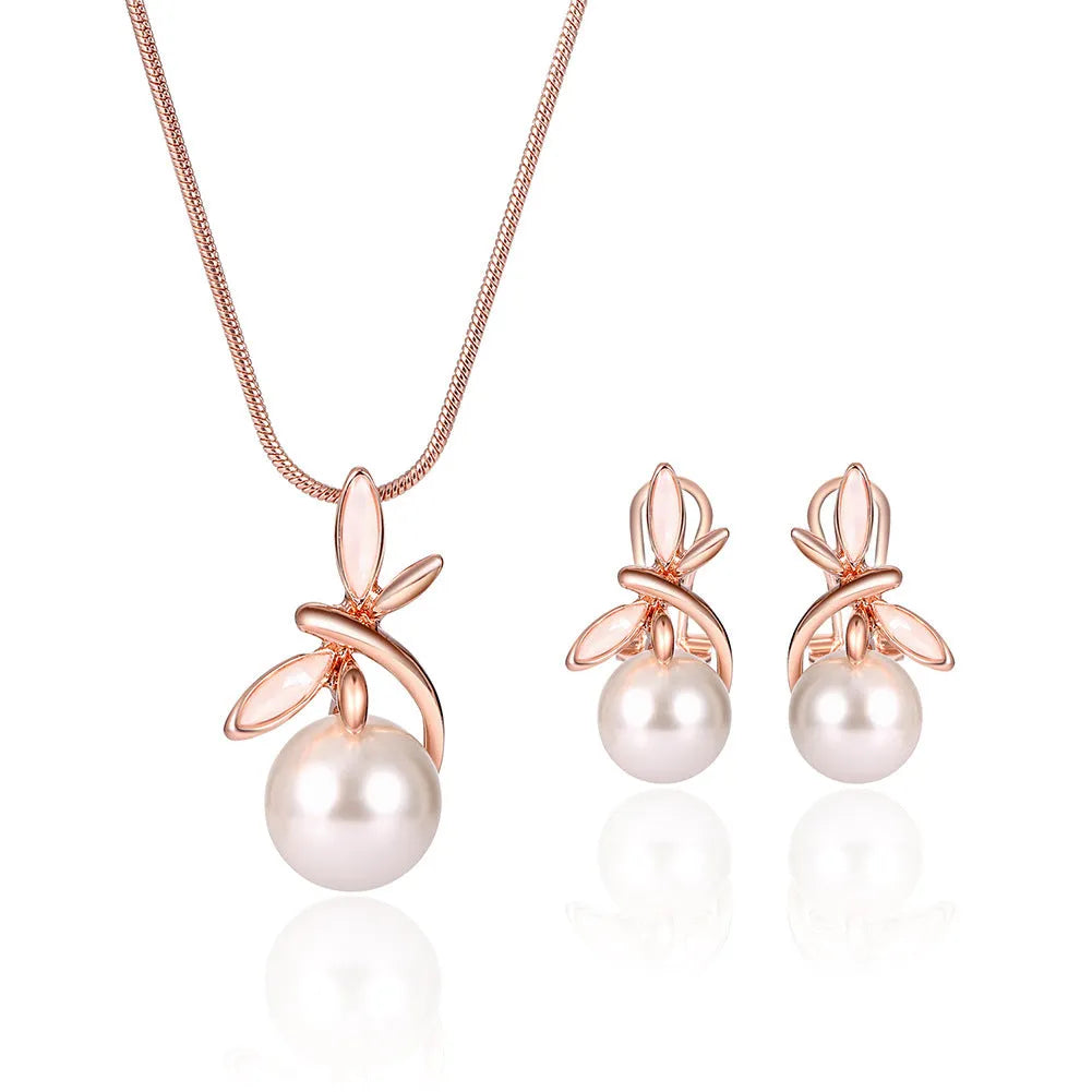 Rose gold bridal jewellery set with pearl necklace and earrings featuring alloy and artificial gems