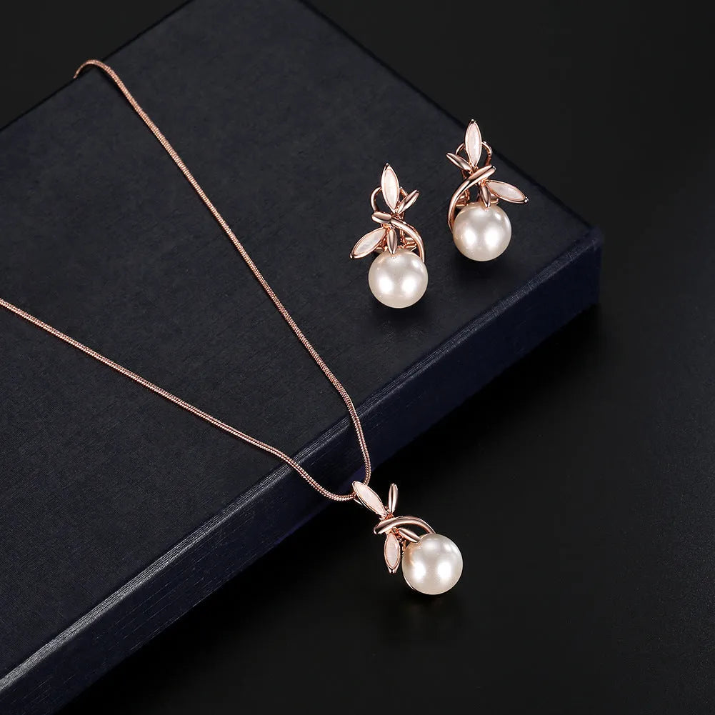 Rose gold bridal jewellery set with pearl necklace and earrings featuring alloy and artificial gems