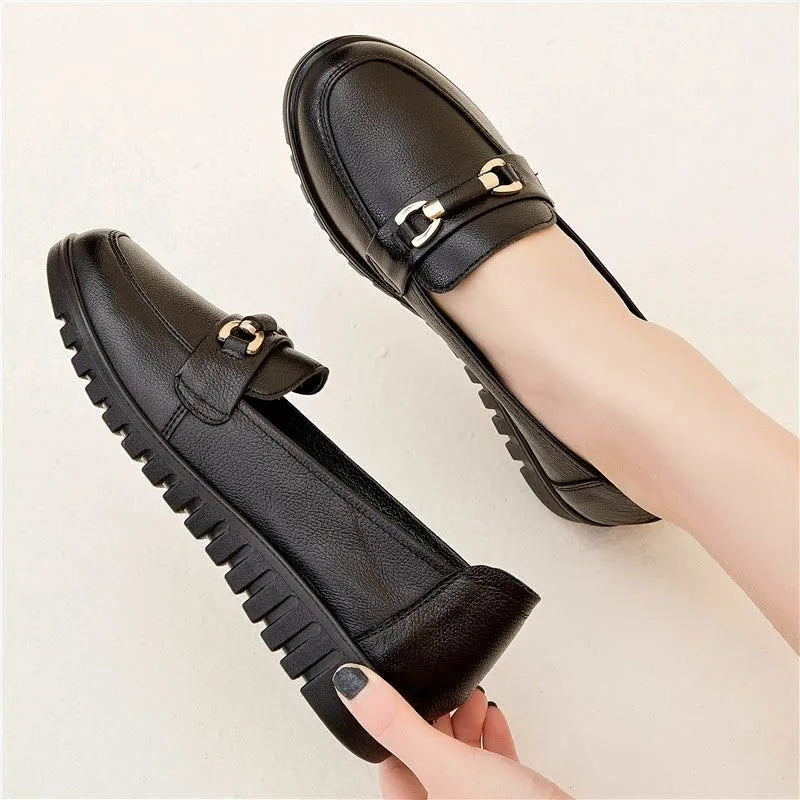 Black women's casual slip-on pumps with round toe, soft sole, and a low flat heel.