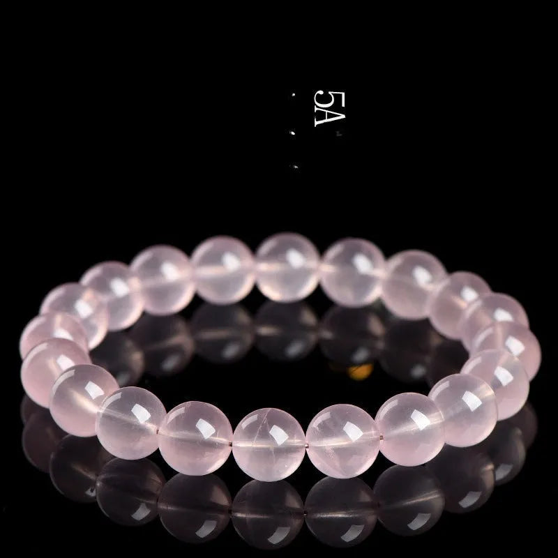 Polished natural crystal bracelet with round pink beads in starlight style, showing colour and size options.