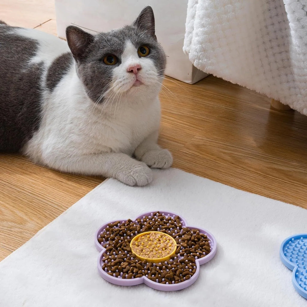 Flower-shaped silicone lick mat for cats and dogs with suction cups on the base, shown in a choice of colours.