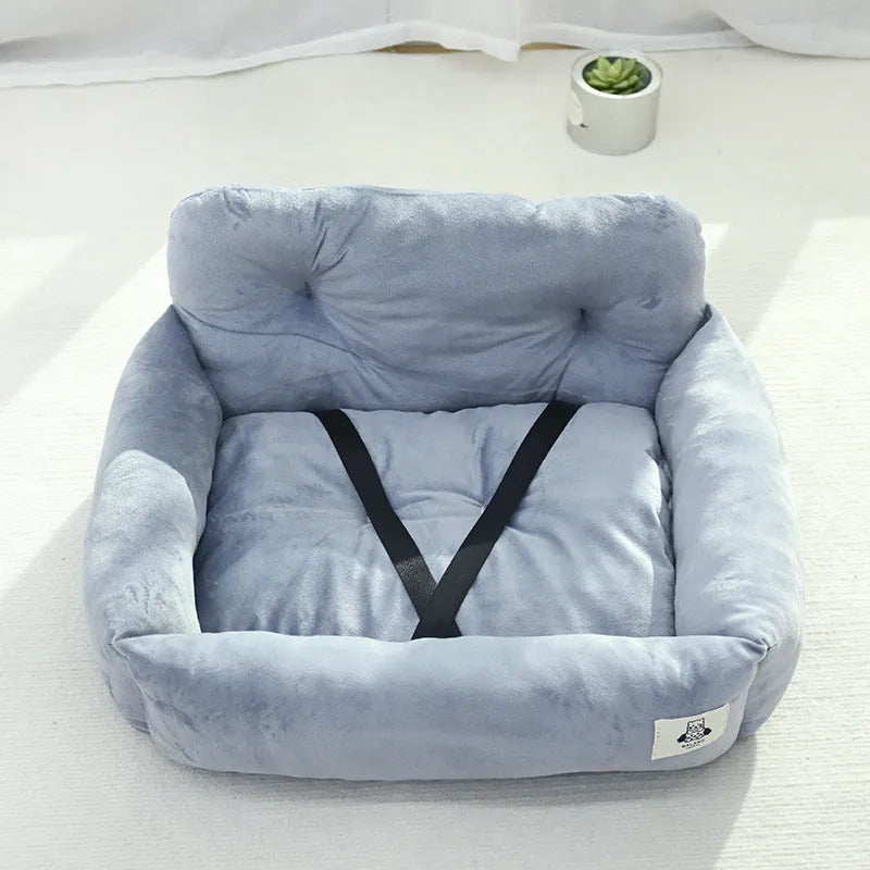 Blue plaid portable dog car bed nest with raised sides, shown on a vehicle seat.