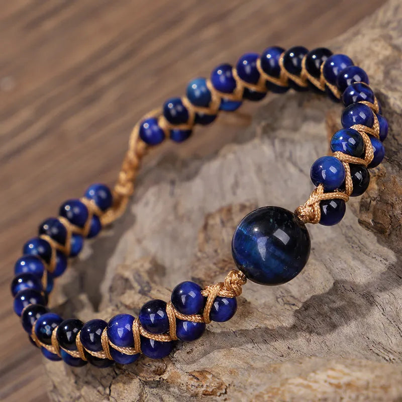 Hand-woven geometric pull bracelet made from blue Tigereye stone beads with an adjustable slip knot.