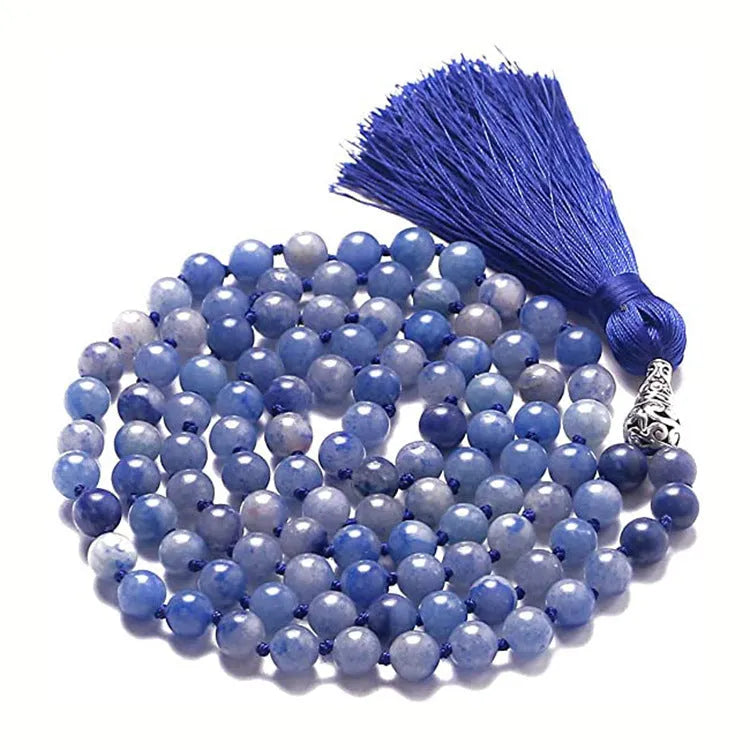 Long agate tassel necklace with geometric beads in multiple natural stone colours on a white background.