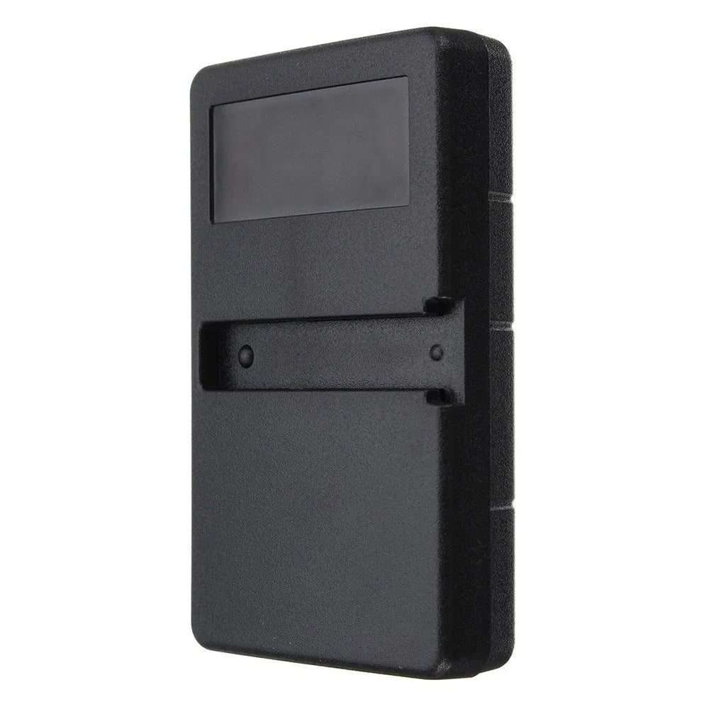 Black plastic three-button garage door remote control next to a CR2032 battery.