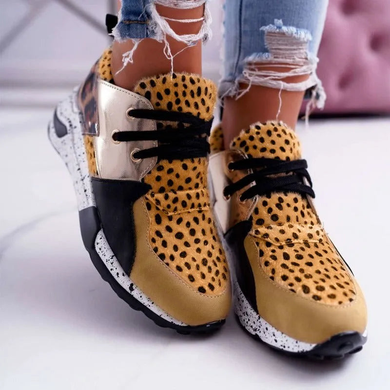 Women's black casual flat sneakers with suede upper and a wedge heel on a breathable fabric base.