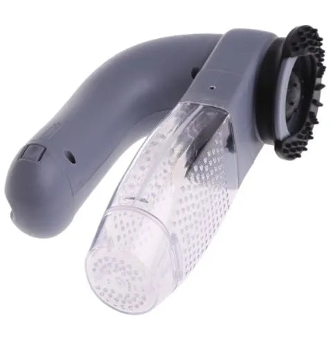 Grey portable pet hair vacuum cleaner with soft rubber grooming head on a fabric sofa