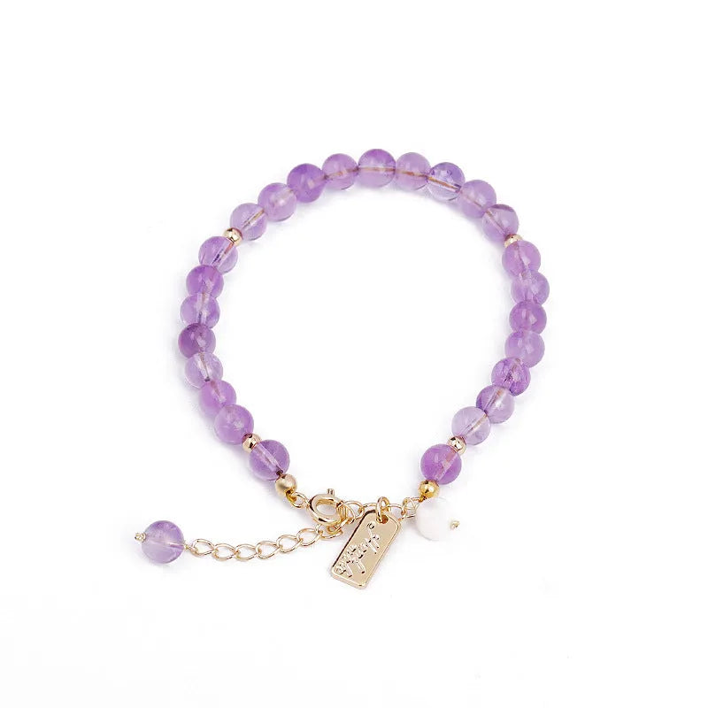 Women's natural crystal bracelet with lavender amethyst stones and animal zodiac design.
