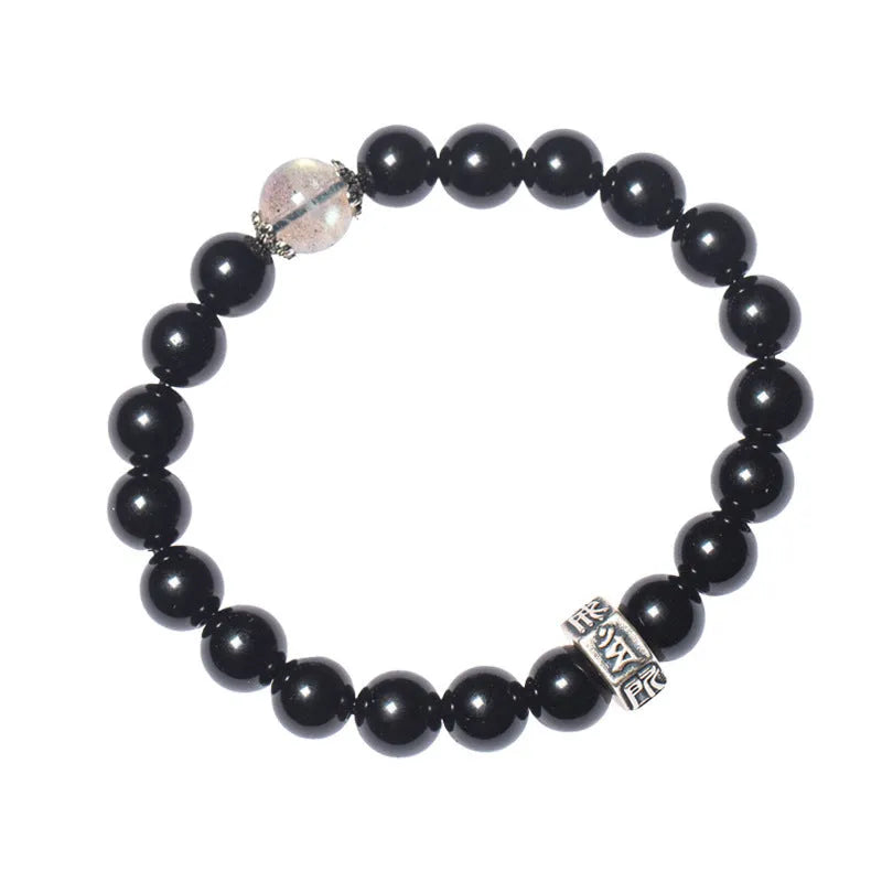 Old Pit Obsidian 8mm bead bracelet with zodiac animal charms on a wrist, showing ethnic style and unset inlaid design.