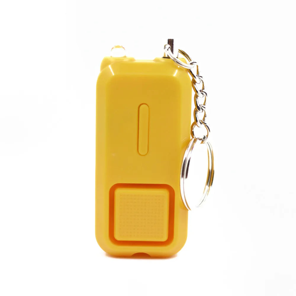 Small pink personal safety alarm with keyring, shown next to its white packaging box.