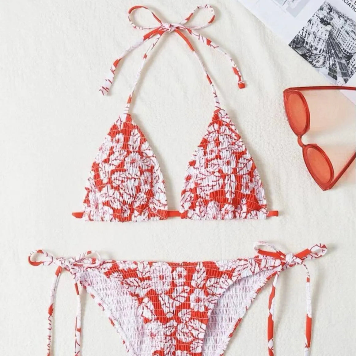 Women's pink floral halter neck swimsuit with briefs on a mannequin.