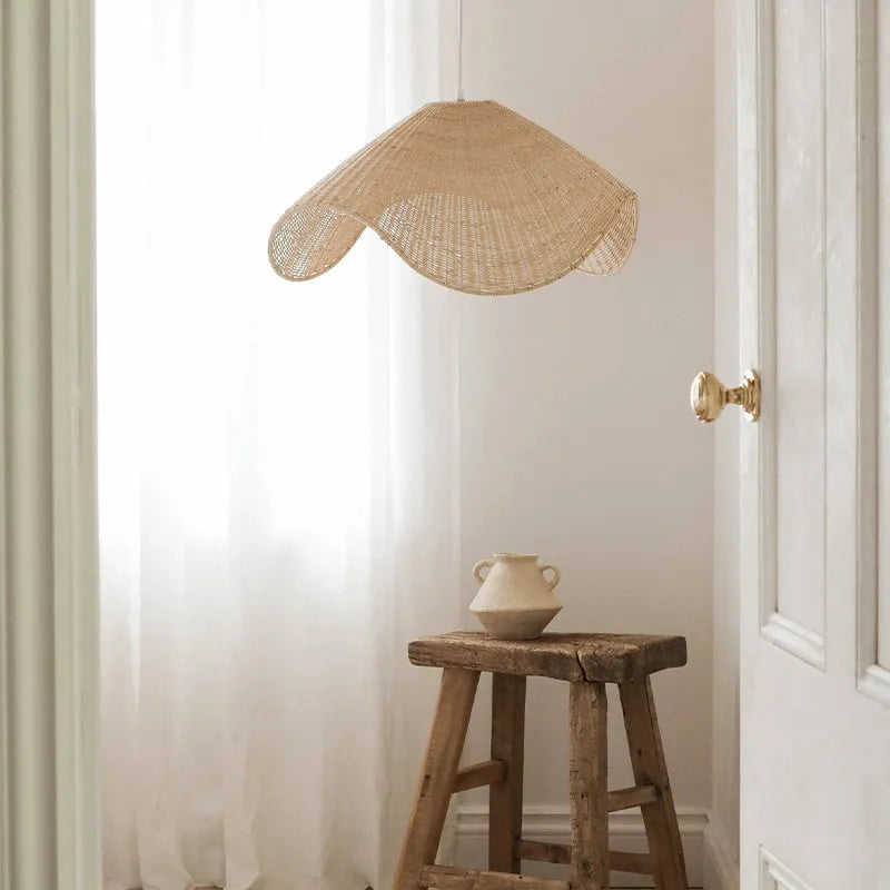 Handmade natural rattan and willow bamboo chandelier with warm LED light in a rustic setting.