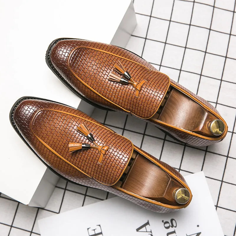 Men's black pointed toe slip-on shoes with a tassel detail on the low-top PU leather upper.