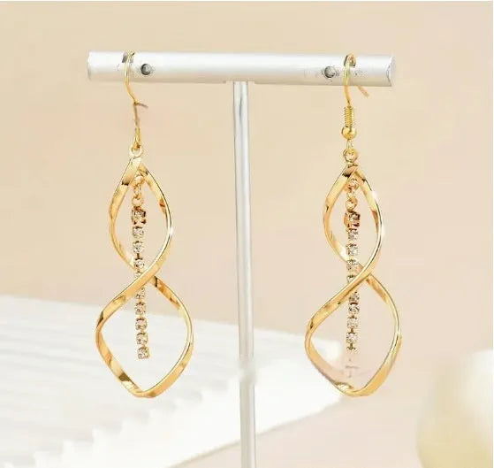 Gold geometric spiral earrings with ellipse elements creating diamond shape design