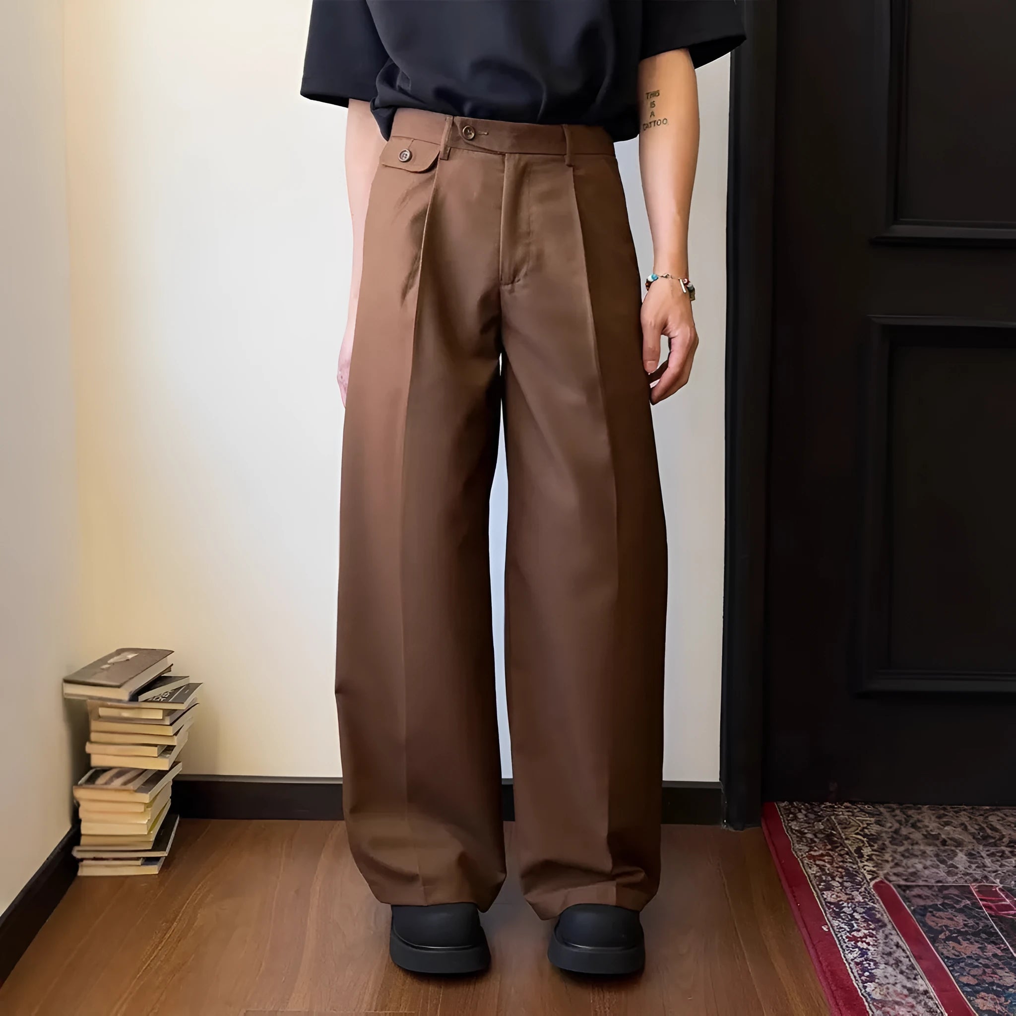 Men's brown straight-leg casual trousers with a loose, wide-leg fit on a neutral background.