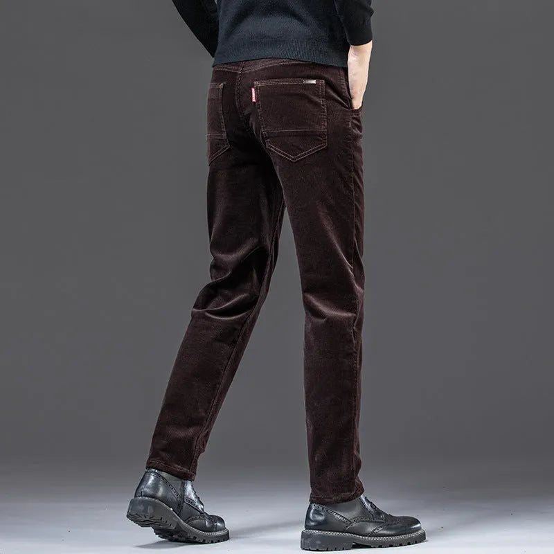 Men's straight slim-fit corduroy trousers in black, cotton fabric, side view on model