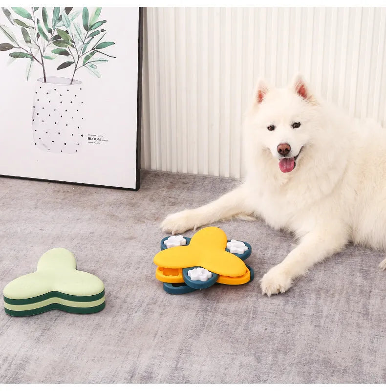 Green and yellow dog puzzle toy with bone covers and rotatable treat dispenser on non-slip base