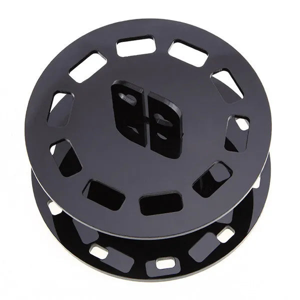 Round black plastic makeup brush holder with 10 holes for storing brushes upright on a vanity or bathroom counter