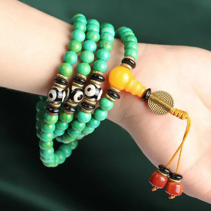 Natural turquoise beaded bracelet with 108 polished 8mm round beads on a wrist.
