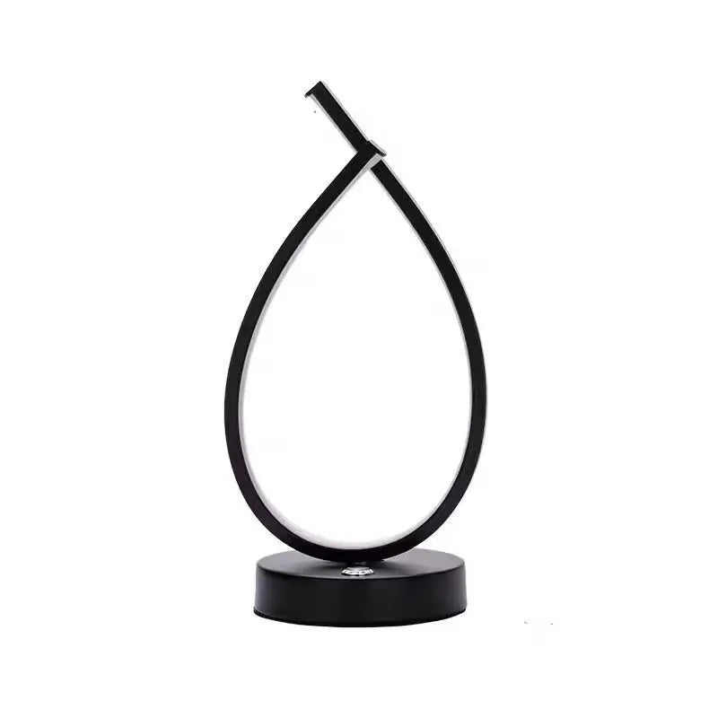 Black and white water drop shaped USB bedside table lamp measuring 30cm tall
