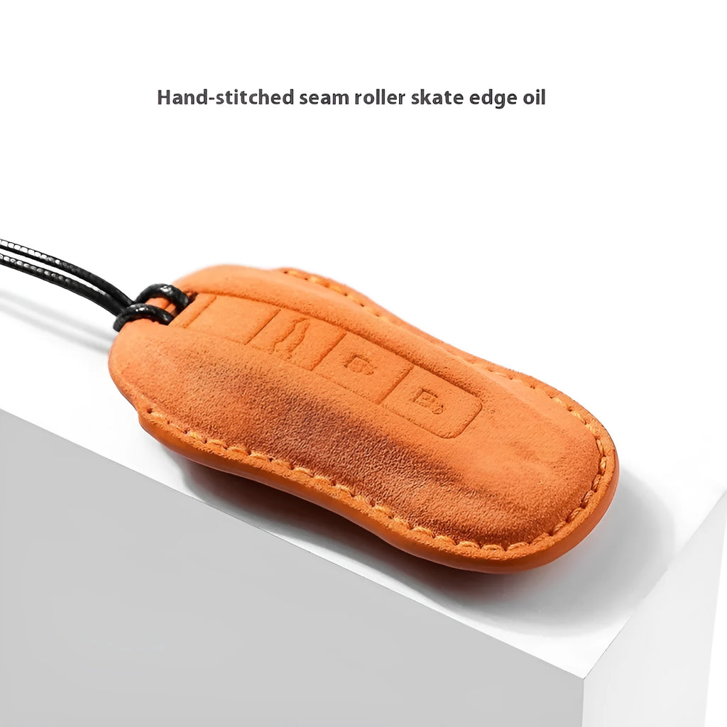 Suede car key cover shown in Cement Gray, Dark Green, Light Gray, and Orange colour options.