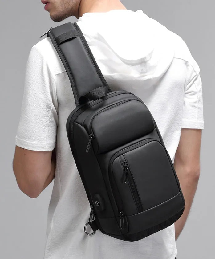 Black medium outdoor shoulder bag showing computer pocket, soft handle, and single air cushion strap.