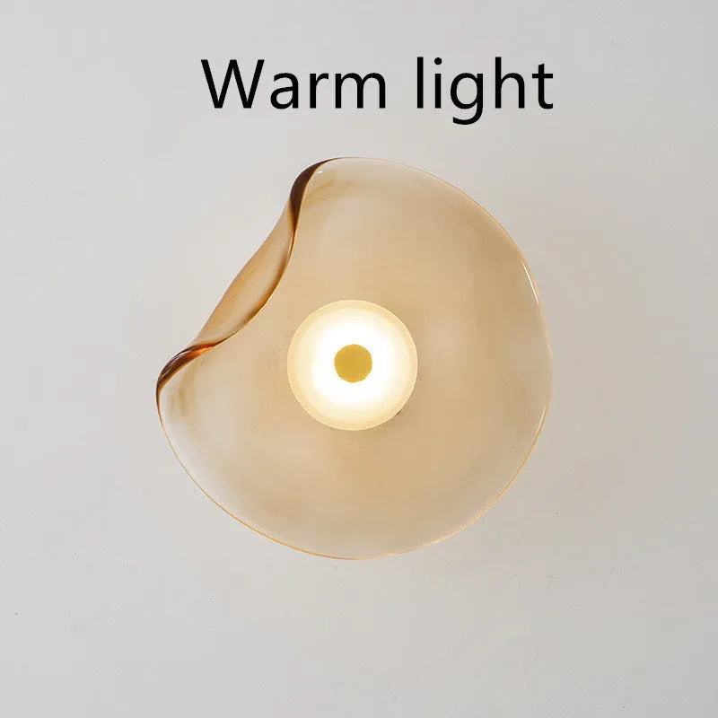 Round decorative wall lamp with glass shade in cognac colour for bedroom bedside lighting
