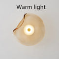 Round decorative wall lamp with glass shade in cognac colour for bedroom bedside lighting