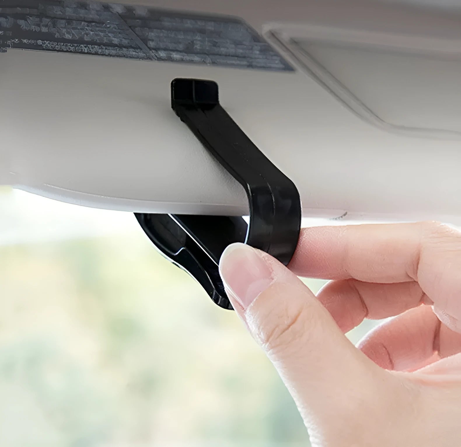 Black plastic car sun visor clip holding sunglasses and cards, measuring 6.5cm by 2.3cm