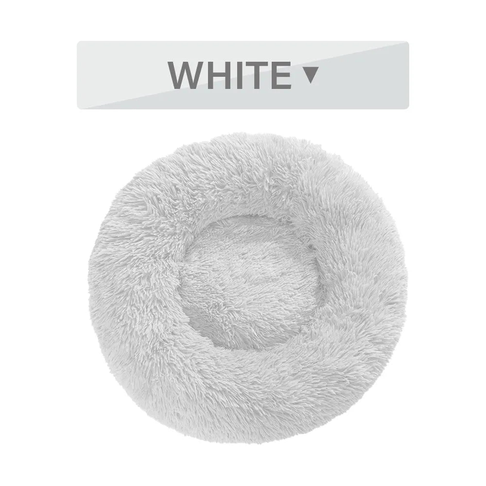 Fluffy donut-shaped dog bed with raised rim in plush fabric, available in multiple colours and four sizes