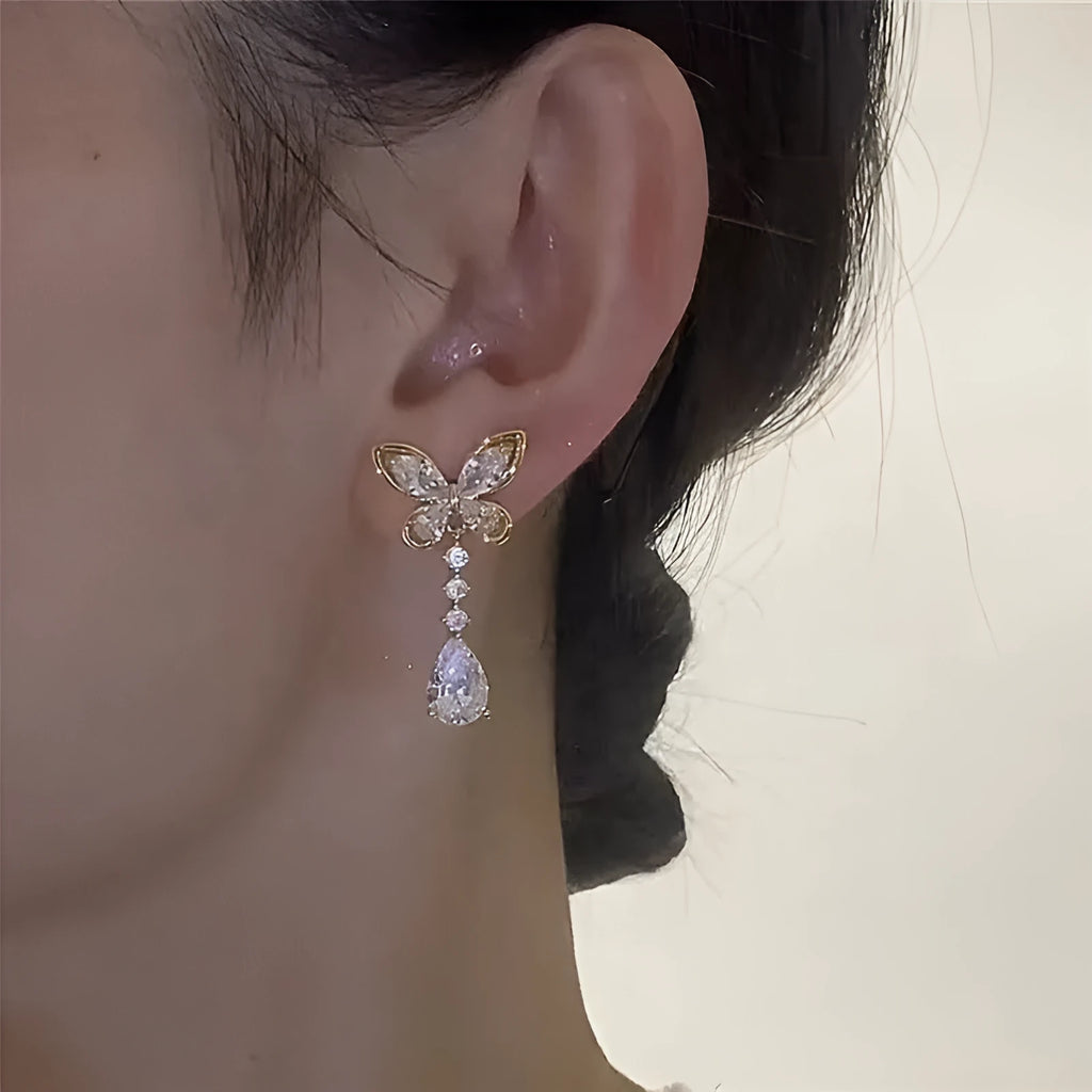 Platinum-coloured bow stud earrings with electroplated zinc alloy construction