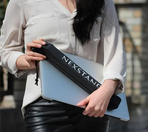 Black folding portable laptop stand made of reinforced nylon, shown in folded position.