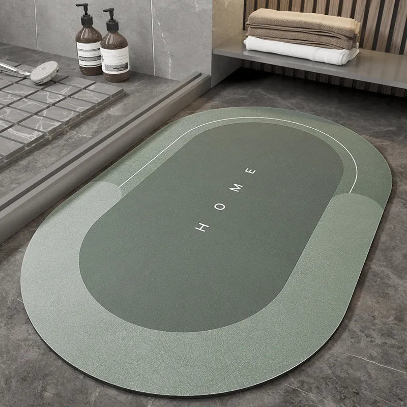 Blended fibre machine woven bathroom floor mat in blue, shown in an oval shape on a tiled floor.