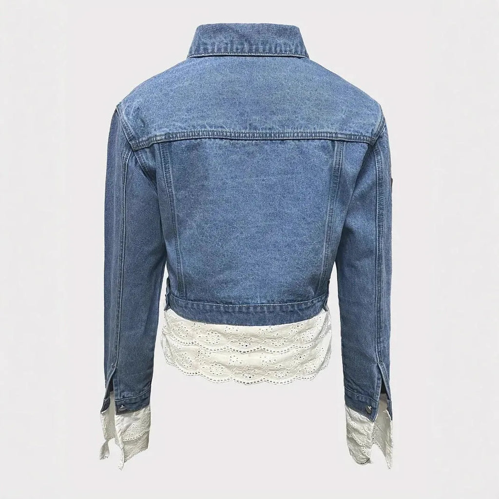 Blue women's denim jacket with white lace stitching on the front, long sleeves.