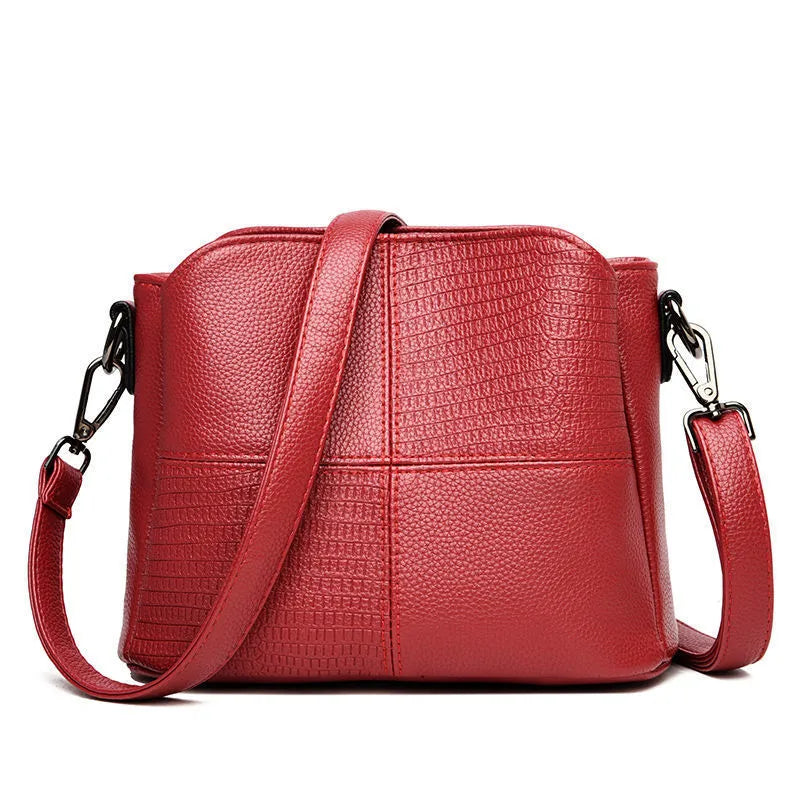 Retro ladies small bucket bag in PU with multilayer zip pockets and double-joint shoulder strap, shown in black, red, or purple.
