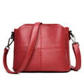Retro ladies small bucket bag in PU with multilayer zip pockets and double-joint shoulder strap, shown in black, red, or purple.