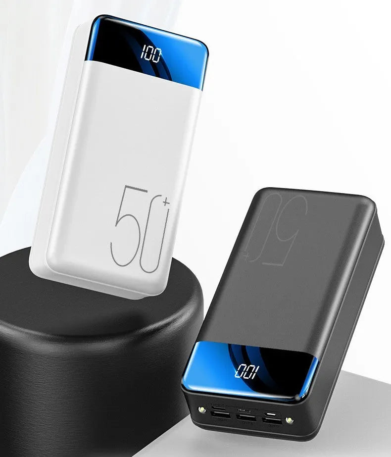 Black and white large 50000mAh power bank with three USB ports showing size scale